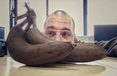 Portrait of man with eyeglasses on table