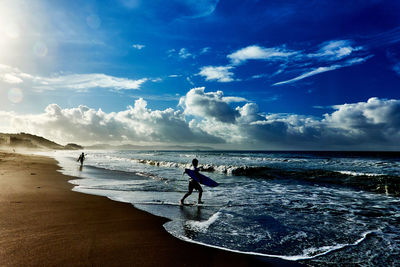 Man on beach against sky in the morning