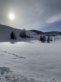 Scenic view of snow covered landscape against sky