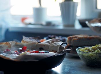 A frying pan just removed from the oven with baked potatoes with vegetables and chum fish, using