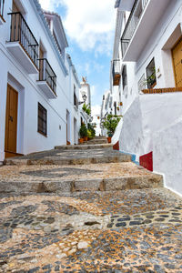 Low angle view of staircase amidst buildings in city