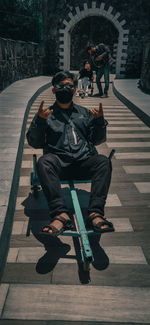 People sitting on footpath