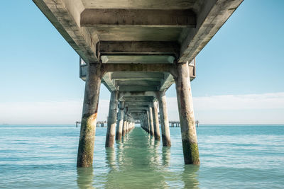 Pier over sea against sky