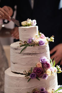 Midsection of bride holding bouquet