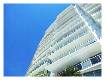 Low angle view of modern building against blue sky