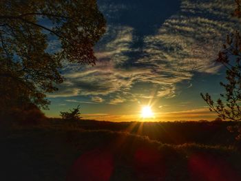 Scenic view of field against sky during sunset