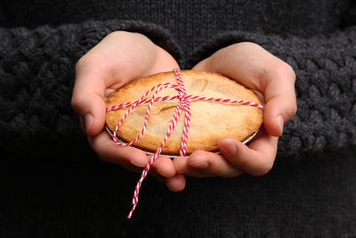 Cropped hand of person holding cookie