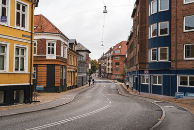 Road amidst buildings in city