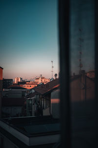 City buildings against clear sky at dusk