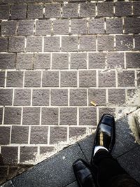 Low section of man standing on sidewalk