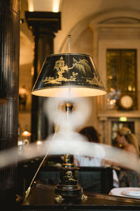 Close-up of illuminated electric lamp on table in restaurant