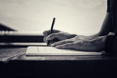 Close-up of man working in pen