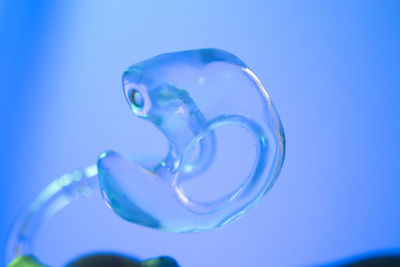 Close-up of water drop against blue background