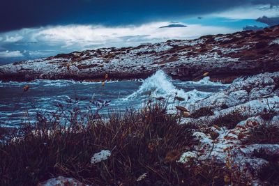 Frozen landscape against sky