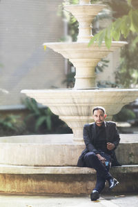 Portrait of young man sitting outdoors