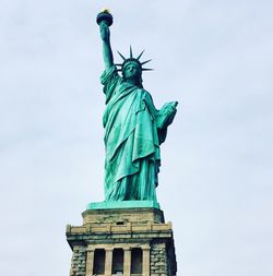 Low angle view of statue of liberty against sky