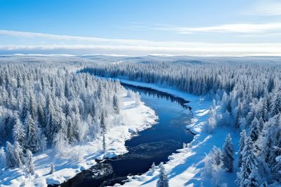 Aerial view of snow covered landscape against sky