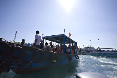 People on boat against clear sky