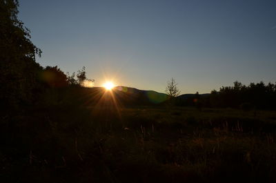 Scenic view of field against sky during sunset