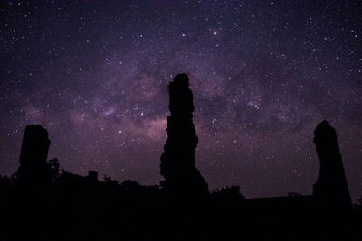 Silhouette people against sky at night