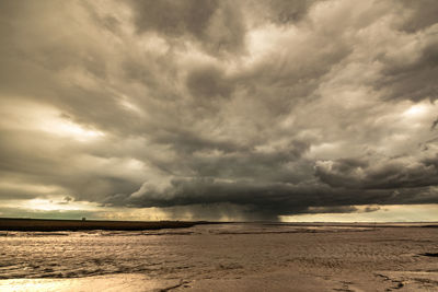 Scenic view of sea against storm clouds