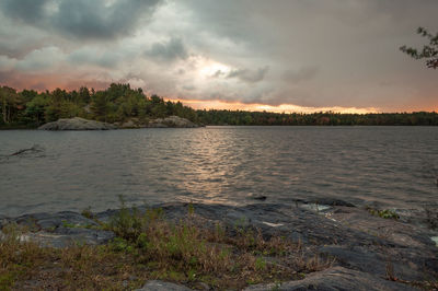 Scenic view of lake against cloudy sky