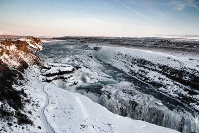 Scenic view of frozen landscape against sky