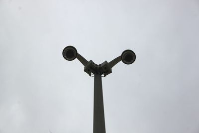 Low angle view of security cameras against clear sky at dusk