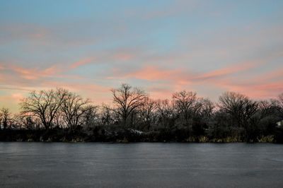 Scenic view of lake against orange sky