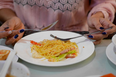 Midsection of person holding ice cream in plate