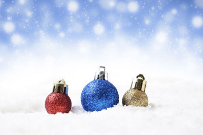 Close-up of baubles on snow