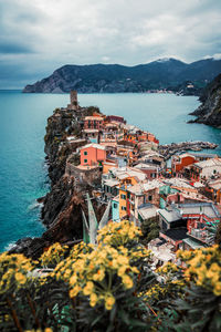 High angle view of townscape by sea against sky