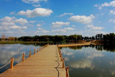 Pier over lake against sky