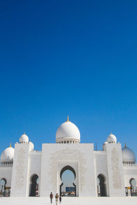 Low angle view of building against clear blue sky