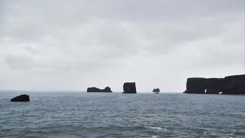 Scenic view of sea against cloudy sky