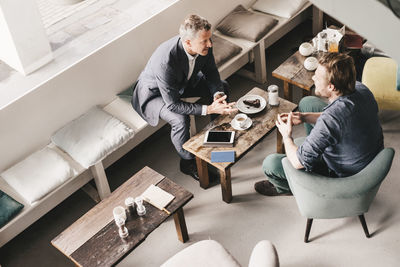 Businessman consulting customer in cafe