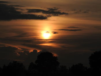 Scenic view of silhouette trees against romantic sky at sunset