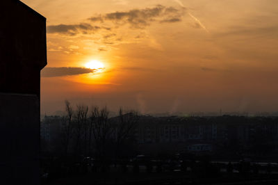 Silhouette buildings against sky during sunset