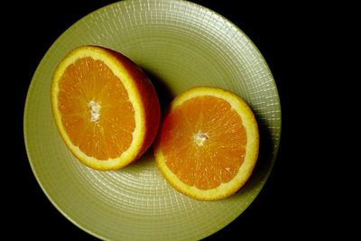 Close-up of orange slices against black background