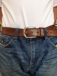 Midsection of mature man wearing brown belt