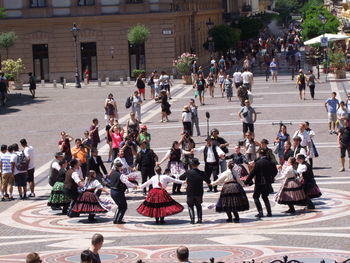 People dancing on street in city