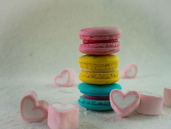 Macaroons and marshmallow on table