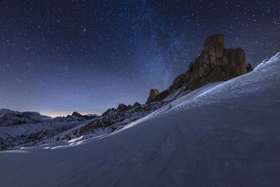 Scenic view of snowcapped mountains against sky at night