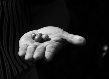 Close-up of human hand against black background