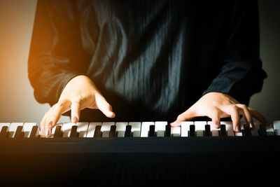 Close-up of hands playing piano