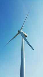 Low angle view of wind turbine against clear sky