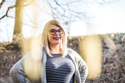 Portrait of smiling young woman standing outdoors