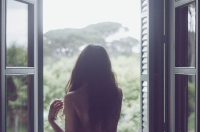 Woman looking through window