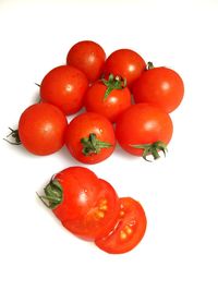 Close-up of tomatoes over white background