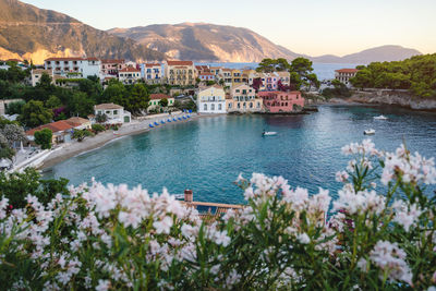 Scenic view of sea by buildings against sky